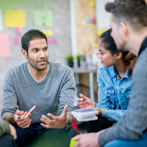 Team members meeting to review progress